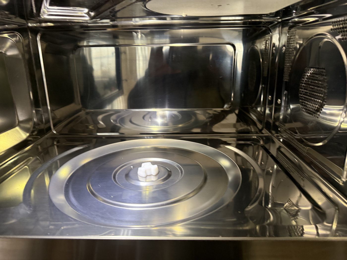 The spotless stainless interior of a commercial oven after an E&L deep clean
